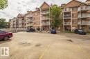 The property features a brick facade with light-colored balconies and multiple windows, offering a classic aesthetic - 326 4304 139 Ave, Edmonton, AB  - Outdoor With Facade 