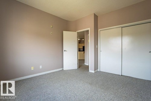 Living space featuring light-colored walls and grey carpet flooring - 326 4304 139 Ave, Edmonton, AB - Indoor Photo Showing Other Room