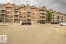 The building features a brick exterior with multiple balconies and a sloped roof - 326 4304 139 Ave, Edmonton, AB  - Outdoor With Facade 