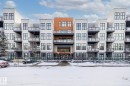 The property features a multi-story building with a modern facade, including a combination of light-colored and wood-toned panels - 114 10531 117 Street, Edmonton, AB  - Outdoor With Facade 