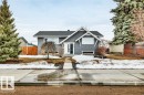 The property features a grey exterior, white trim, and a prominent white front door with vertical glass inserts - 6719 94B Avenue, Edmonton, AB  - Outdoor 