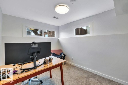 The room features light-colored carpeting, a white ceiling with a flush-mount light fixture, and white walls - 6719 94B Avenue, Edmonton, AB - Indoor Photo Showing Office