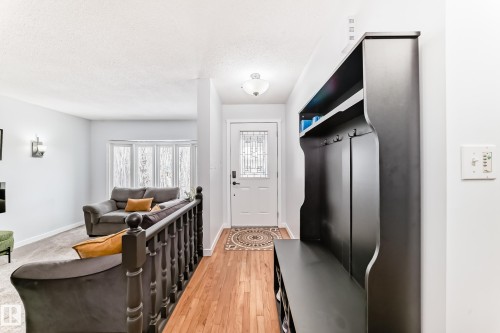 Inviting entryway with hardwood floors leading to a spacious living area featuring a bay window - 17819 91A Street, Edmonton, AB - Indoor Photo Showing Other Room