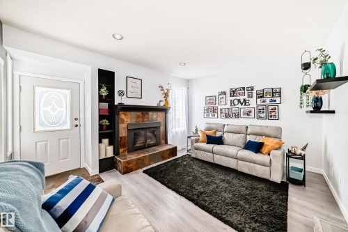 Bright living space with light-toned flooring and recessed lighting - 17819 91A Street, Edmonton, AB - Indoor Photo Showing Living Room With Fireplace