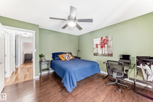 This room features dark hardwood flooring and light green walls - 17819 91A Street, Edmonton, AB - Indoor Photo Showing Bedroom