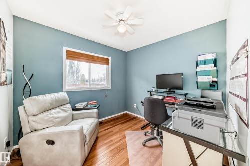 This room features hardwood flooring, light blue walls, and a window with a wooden blind - 17819 91A Street, Edmonton, AB - Indoor Photo Showing Office