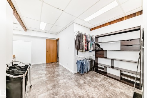 The property features a spacious room with a drop ceiling, recessed lighting, and a durable tile floor - 17819 91A Street, Edmonton, AB - Indoor Photo Showing Other Room