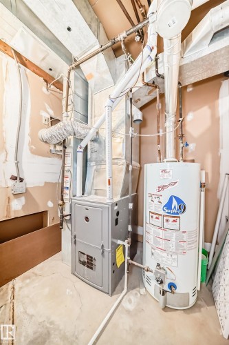 The property includes a water heater and a furnace, both visible in this utility area - 17819 91A Street, Edmonton, AB - Indoor Photo Showing Basement