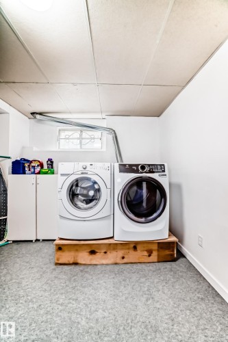 Dedicated laundry area featuring a washer and dryer, white cabinetry, and a small window - 17819 91A Street, Edmonton, AB - Indoor Photo Showing Laundry Room