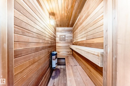 Sauna with wood paneling, wood benches, and a wall-mounted heater - 17819 91A Street, Edmonton, AB - Indoor Photo Showing Other Room