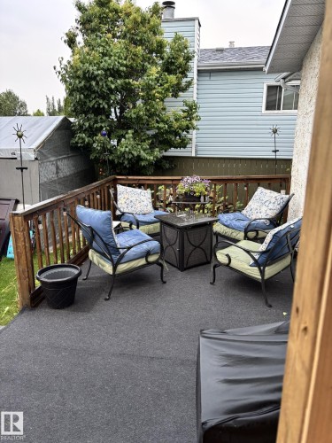 The property features a private outdoor deck with a wooden railing and a textured floor - 17819 91A Street, Edmonton, AB - Outdoor With Exterior