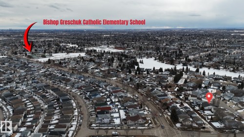 Aerial view of a residential neighbourhood with a visible school and a body of water - 17819 91A Street, Edmonton, AB - Outdoor With View