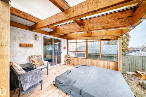 Enclosed patio featuring wooden beams, a sliding glass door, and exterior windows - 17819 91A Street, Edmonton, AB - Outdoor With Deck Patio Veranda With Exterior