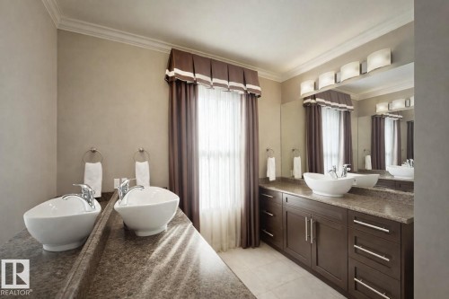 Well-appointed bathroom featuring dual vessel sinks set on a spacious countertop, a large vanity mirror with overhead lighting, and custom window treatments - 6712 18 Ave Sw Sw, Edmonton, AB - Indoor Photo Showing Bathroom