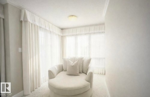 This room features wall-to-wall carpeting, white walls, and a ceiling light fixture - 6712 18 Ave Sw Sw, Edmonton, AB - Indoor