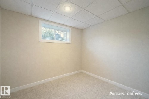 This room features neutral-toned walls, light-colored carpeting, a window with a white frame, and a ceiling with recessed lighting - 6712 18 Ave Sw Sw, Edmonton, AB - Indoor Photo Showing Other Room