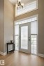 Inviting entryway featuring light-toned flooring, a tall ceiling, and an overhead light fixture - 6712 18 Ave Sw Sw, Edmonton, AB  - Indoor Photo Showing Other Room 