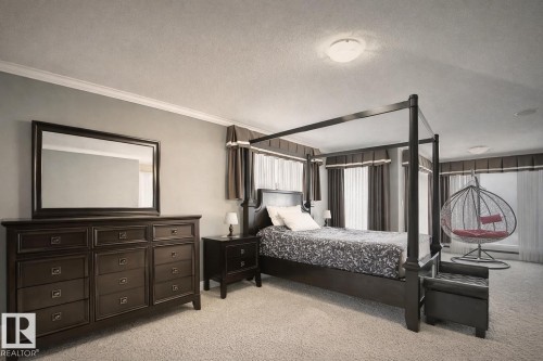 This bedroom features carpeting, light grey walls, and windows with curtains - 6712 18 Ave Sw Sw, Edmonton, AB - Indoor Photo Showing Bedroom