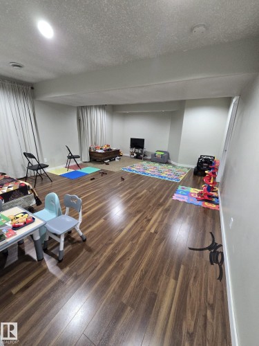 This expansive room features hard surface flooring and recessed lighting, offering a versatile space - 3311 21 Street, Edmonton, AB - Indoor