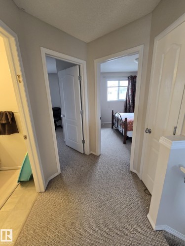 Hallway featuring carpeted flooring and light-colored walls - 3311 21 Street, Edmonton, AB - Indoor