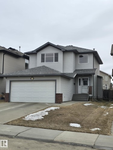 The property features light gray siding, a two-car garage, and a front entry with steps - 3311 21 Street, Edmonton, AB - Outdoor With Facade