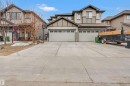 The property features a concrete driveway and two attached garages with white doors - 2314 22 Avenue, Edmonton, AB  - Outdoor With Facade 