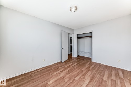 The room features light-colored walls and wood-look flooring - 12411 126 Street Nw, Edmonton, AB - Indoor Photo Showing Other Room