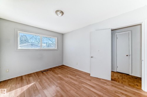 Room featuring light wood flooring, white walls, and a window providing natural light - 12411 126 Street Nw, Edmonton, AB - Indoor Photo Showing Other Room