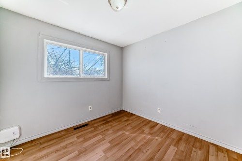 Room with light gray walls and wood-look flooring - 12411 126 Street Nw, Edmonton, AB - Indoor Photo Showing Other Room