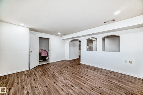 This room features wood-look flooring, white walls, and recessed lighting - 12411 126 Street Nw, Edmonton, AB - Indoor Photo Showing Other Room