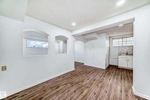 Living space featuring wood-look flooring, recessed lighting, and white walls - 12411 126 Street Nw, Edmonton, AB - Indoor