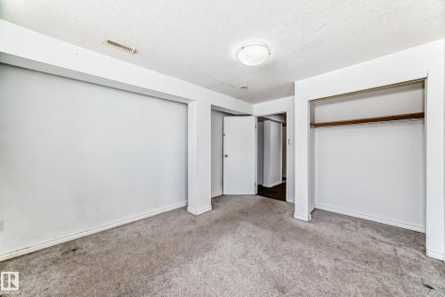 The room features light-colored walls and carpeted flooring, creating a neutral canvas - 12411 126 Street Nw, Edmonton, AB - Indoor Photo Showing Other Room