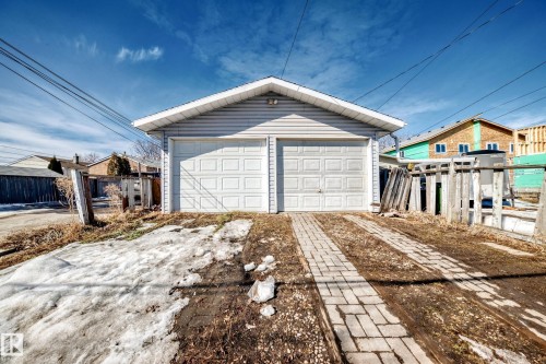 Detached two-car garage with light-colored siding and a paved driveway - 12411 126 Street Nw, Edmonton, AB - Outdoor