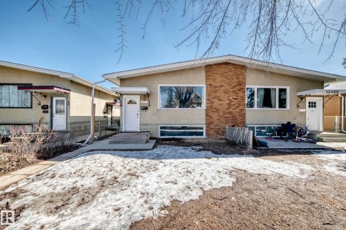 The property features a stucco exterior with brick accents and multiple windows - 12411 126 Street Nw, Edmonton, AB - Outdoor