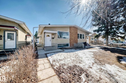 The property features a front yard with a concrete walkway and a visible front entrance - 12411 126 Street Nw, Edmonton, AB - Outdoor