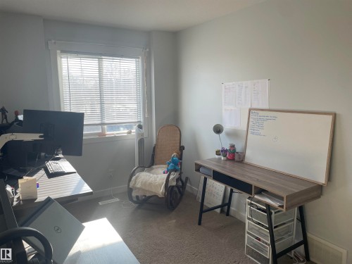 This room features light-colored walls and carpeted flooring - 15220 105 Avenue, Edmonton, AB - Indoor