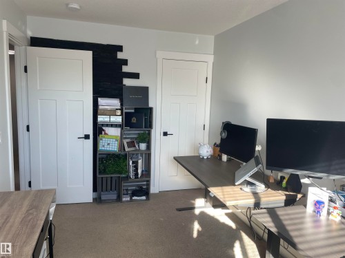This room features light-colored walls and carpeted flooring - 15220 105 Avenue, Edmonton, AB - Indoor Photo Showing Other Room