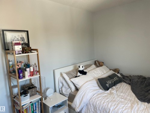 This bedroom features light grey walls and a white headboard - 15220 105 Avenue, Edmonton, AB - Indoor Photo Showing Bedroom