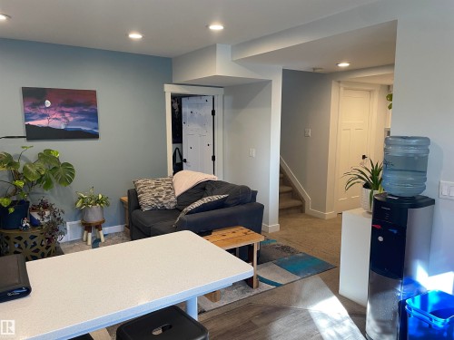 This inviting living space features recessed lighting and light blue walls - 15220 105 Avenue, Edmonton, AB - Indoor