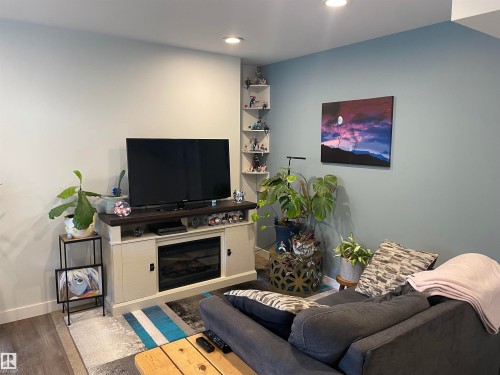 The living area features recessed lighting and a corner shelving unit - 15220 105 Avenue, Edmonton, AB - Indoor