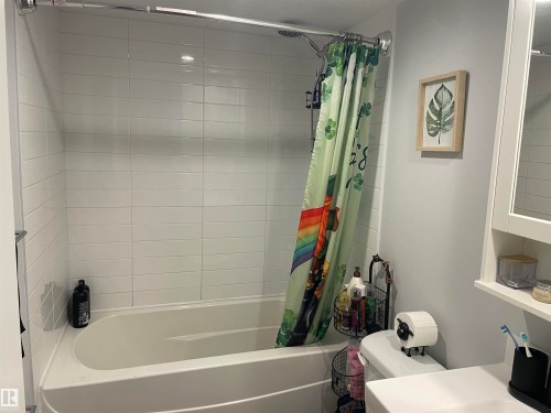 Bathroom featuring a shower and tub combination with white subway tile surround - 15220 105 Avenue, Edmonton, AB - Indoor Photo Showing Bathroom