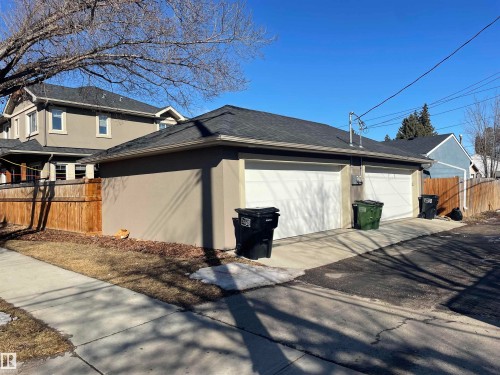 Detached two-car garage with white garage doors and a paved driveway - 15220 105 Avenue, Edmonton, AB - Outdoor