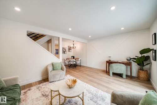 Living area featuring recessed lighting, light wood-style flooring, and a decorative accent wall - 125 Woodborough Way, Edmonton, AB - Indoor Photo Showing Living Room