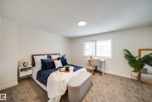 Bedroom featuring a window providing natural light, white walls, and carpet flooring - 125 Woodborough Way, Edmonton, AB - Indoor Photo Showing Bedroom