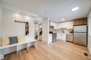The property features an open-concept layout with light wood flooring throughout - 125 Woodborough Way, Edmonton, AB  - Indoor Photo Showing Kitchen 