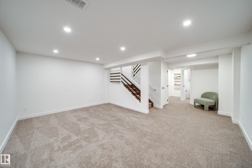 Spacious room featuring carpeting, recessed lighting, and white walls - 125 Woodborough Way, Edmonton, AB - Indoor