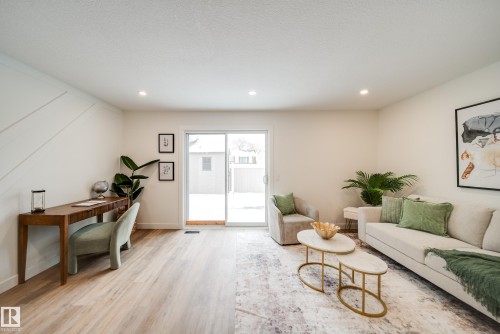 The living area features light wood-style flooring, white walls, and recessed lighting - 125 Woodborough Way, Edmonton, AB - Indoor