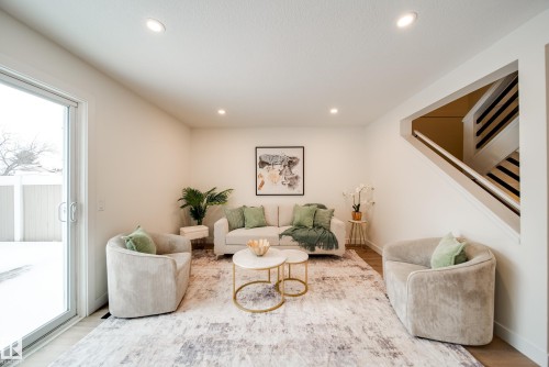 Bright living area with recessed lighting, a sliding glass door, and light-toned flooring - 125 Woodborough Way, Edmonton, AB - Indoor Photo Showing Living Room