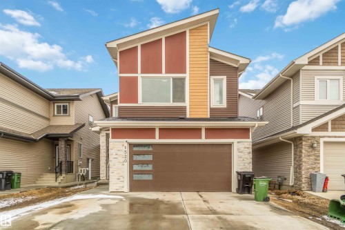 This property features a contemporary exterior with multi-toned siding and stone accents - 1520 151 Avenue, Edmonton, AB - Outdoor
