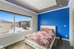 This room features a vibrant blue accent wall and recessed lighting in the ceiling - 